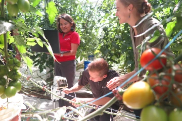 Karletta Chief working on agricultural research with other scientists.